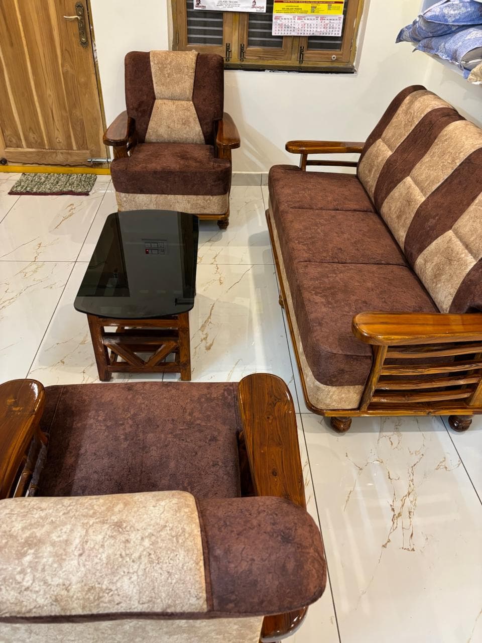 Living area with traditional wooden chairs and marble floors