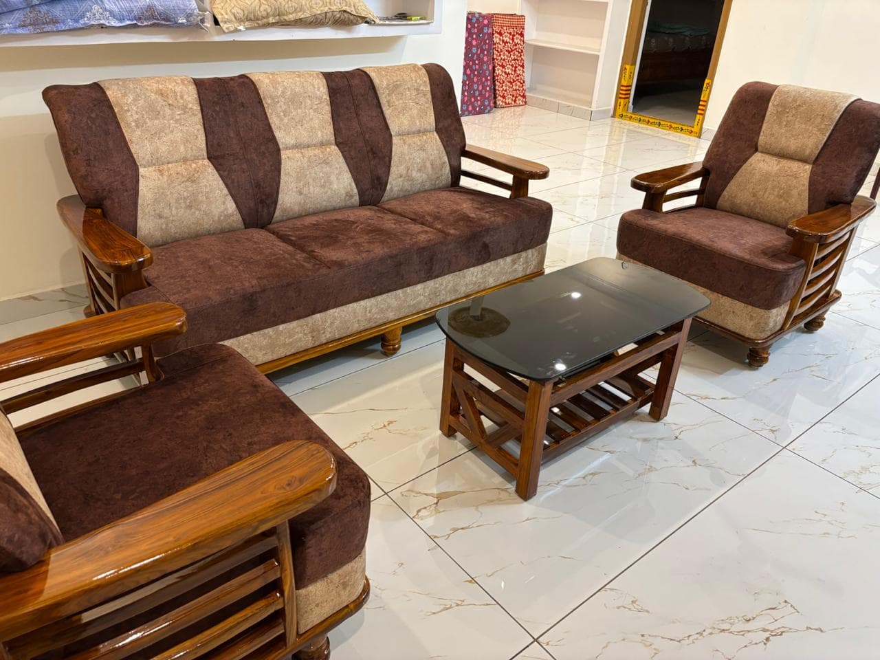 Wooden sofa set and glass coffee table in the living room